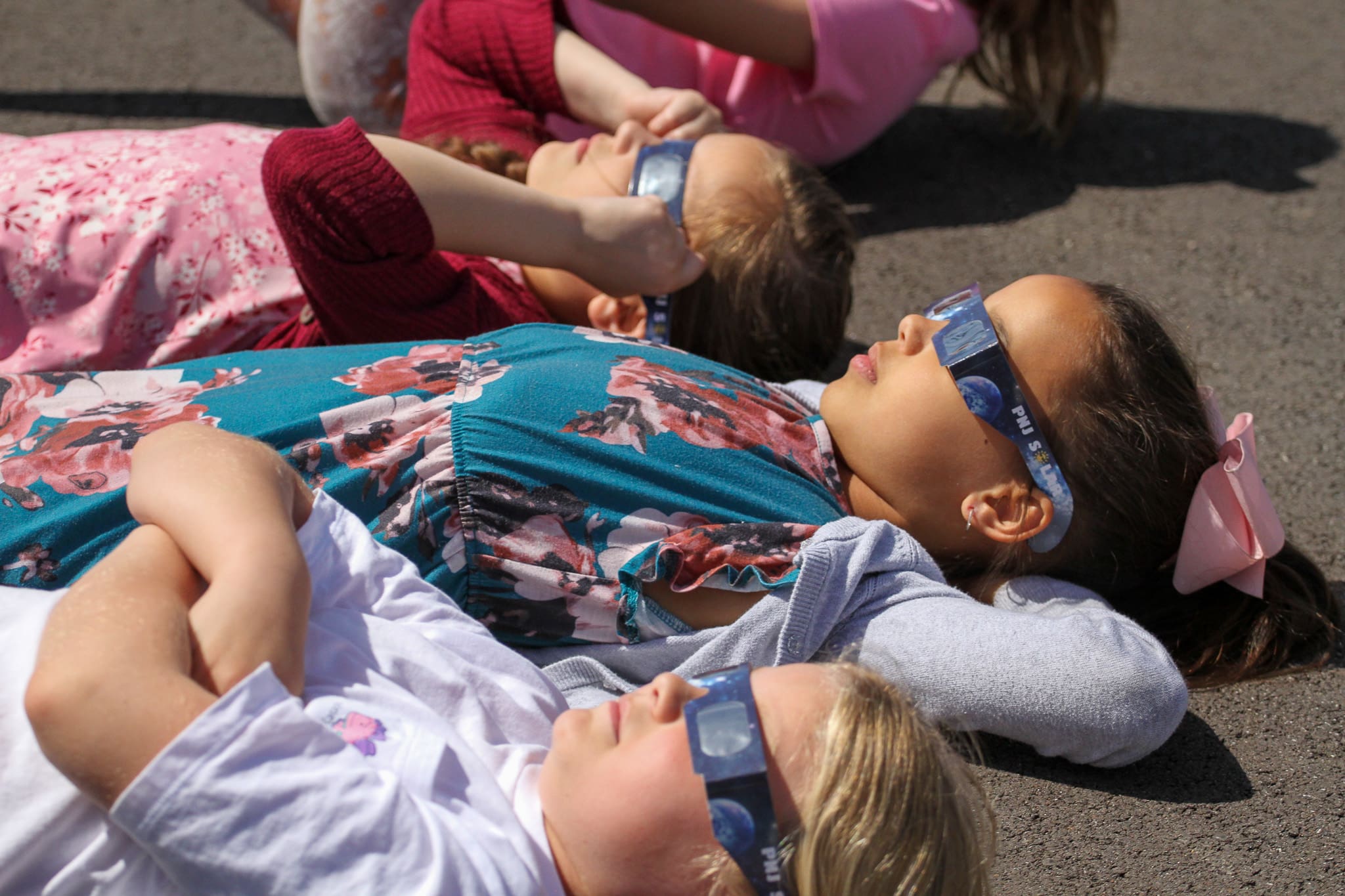 An elementary student wearing Solar Eclipse glasses. 